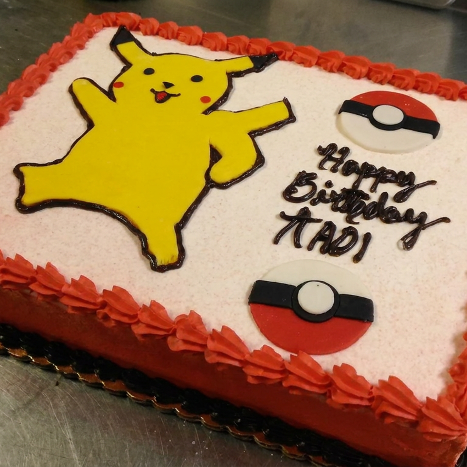 Rectangular Pokémon-themed birthday cake decorated with Pikachu, Poké Balls, red frosting borders, and a birthday message.